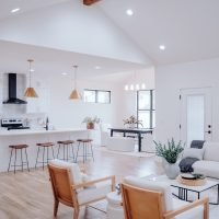 a living room filled with furniture and a kitchen